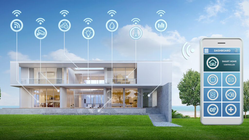 A modern smart home is shown with connected home automation features, including lighting, security, temperature control and energy monitoring. A smartphone app dashboard is displayed beside the house, illustrating remote control of smart home systems via wireless connectivity.
